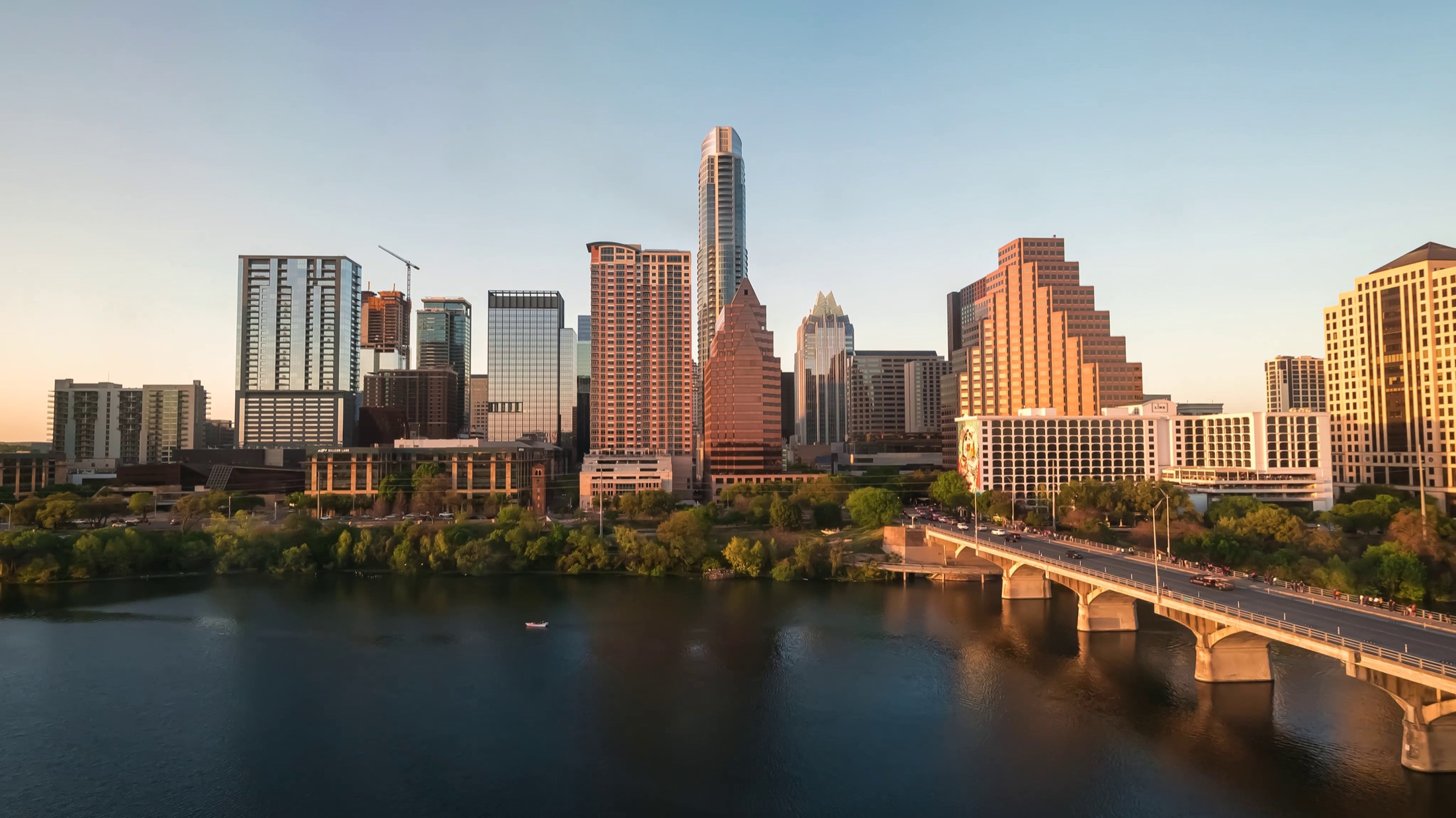 Downtown Austin skyline beside the Colorado River at sunset
