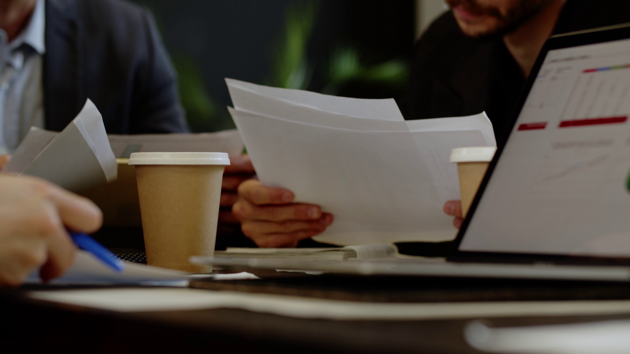 Business team reviewing documents during production planning